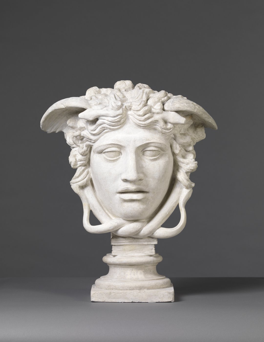 2 The black-and-white photograph shows a cast of a marble sculpture of the Capitoline Venus, a nude young woman in front of a light-coloured background.
