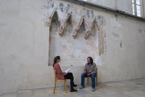 A researcher conducts an interview with a conservator